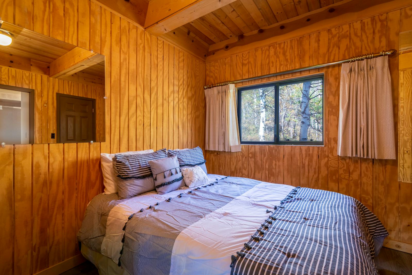 Queen Room — bed and warm bedside lamp